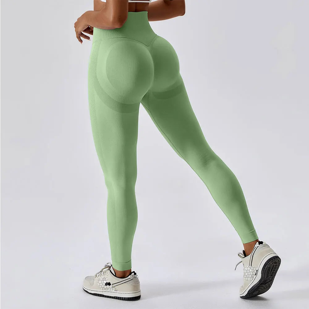 PowerCurve green high-waist leggings with scrunch detail for enhanced curves, made of moisture-wicking nylon and spandex, ideal for yoga and fitness.